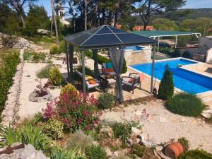 a patio with a gazebo next to a pool at Holiday Home Ela in Dračevica