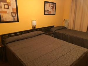 Llit o llits en una habitació de Hotel Refugi dels Isards