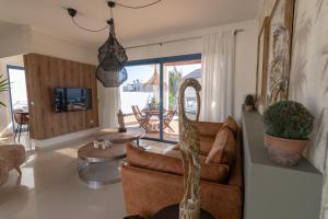 ein Wohnzimmer mit einem Sofa und einem Tisch in der Unterkunft Villalia Famara in Playa Blanca