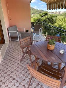 un tavolo e sedie in legno su un patio di B&B Casa Gianfranca a Portoferraio