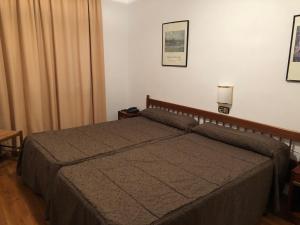 Llit o llits en una habitació de Hotel Refugi dels Isards