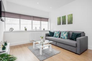 a living room with a couch and a table at 2 Bedroom Apartment At Modernview Serviced Accommodation Watford Town Centre F15 in Watford