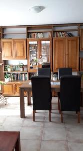 a dining room with a table and chairs and cabinets at Guesthouse Kohári in Egerszalók