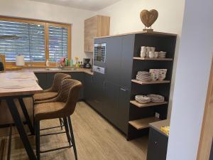 a kitchen with two bar stools and a counter at Appartement Mountain Lake in Maurach