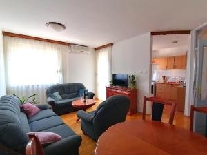 a living room with a couch and chairs and a table at Apartman Park in Trebinje