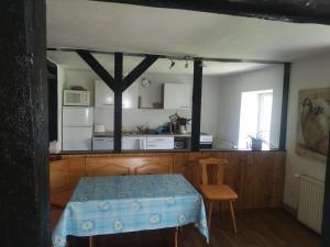 a room with a table and a kitchen with a table sidx sidx at Ferienhaus Salmtal Himmerod in Großlittgen