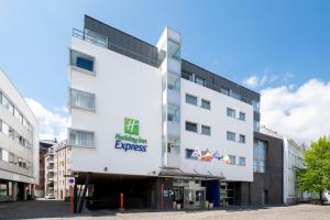 a large building with a sign on the side of it at Holiday Inn Express Mechelen City Centre, an IHG Hotel in Mechelen