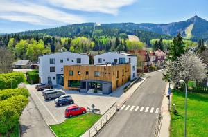 a small town with cars parked in a parking lot at Wellness Hotel Fénix in Liberec