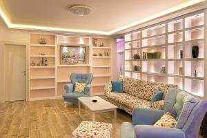 a living room with a couch and two chairs at Villa Latina 2 in Budva