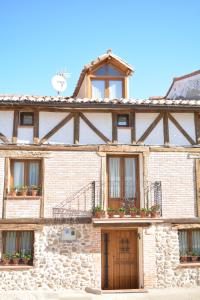 um grande edifício de pedra com janelas e varandas em La Casa de Villar em Villar de Torre