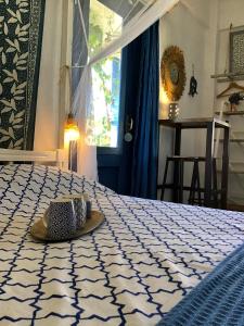 a hat sitting on a bed in a room at Chez Cécile Home in Mochlos