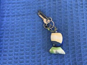 a key chain with a vase on a blue surface at Chez Cécile Home in Mochlos