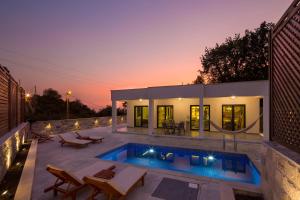 a villa with a swimming pool at dusk at Villa Latina 2 in Budva