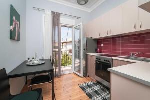 a kitchen with a table and a stove top oven at Sivylla Apartments in Lefkada