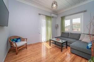 a living room with a couch and a table at Sivylla Apartments in Lefkada
