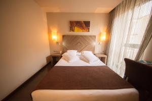 Postel nebo postele na pokoji v ubytování Hotel Aroi Ponferrada