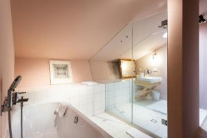 a bathroom with a tub and a sink at Gut Sonnenhausen in Glonn