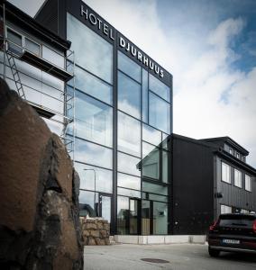 a building with a sign that reads hotel durpheus at Hotel Djurhuus in Tórshavn