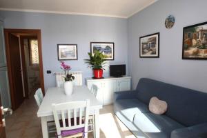 a living room with a blue couch and a table at Casa Mirella - Toscolano Maderno in Toscolano Maderno