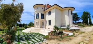 a large white house with a tower on top of it at Domus Mare Cilento in Agropoli