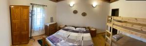 a small room with a bed and a window at Под старата липа in Goritsa