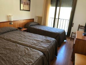 Postel nebo postele na pokoji v ubytování Hotel Refugi dels Isards + 27 fotografií