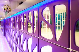 a purple wall with blue lights on it at Holidays Home in Pattaya South +16 photos