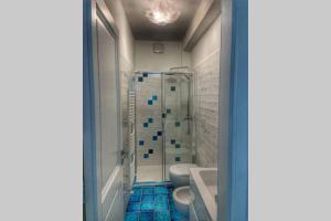 a bathroom with a shower and a toilet at Casa Ministro in Positano
