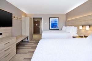 Holiday Inn Express & Suites - Wooster, an IHG Hotel في ووستر: غرفة فندقية بسريرين وتلفزيون بشاشة مسطحة