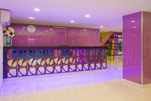 a room with purple walls and a counter with cosmetics at Holidays Home in Pattaya South