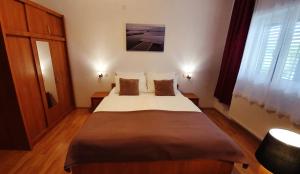 a bedroom with a large bed in a room at Adriasobe in Vodice