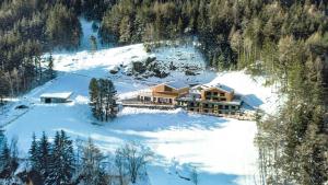 an aerial view of a house in the snow at Archehof Hochzirm Lodge Johanna in Campo Tures