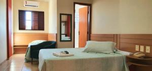 a hotel room with a bed with a mirror and a mirror at Colorado Plaza Hotel in Rio Verde +42 photos