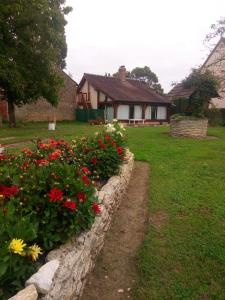 Ein Haus mit einem Blumenstrauß im Hof. in der Unterkunft LA CAMPAGNETTE in Canteloup