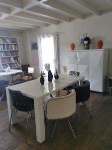 a dining room with a white table and chairs at Chambres d'hôtes Chez Valérie in Arette