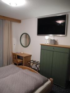 a bedroom with a bed and a television on the wall at Piccard Obergurgl in Obergurgl