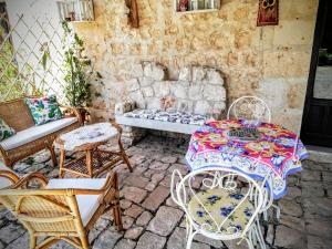 a patio with a table and chairs and a couch at Torre Rodosta in Modica