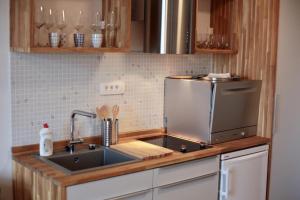 
a kitchen with a stove top oven and a sink at Apartments Cava Dubrovnik in Dubrovnik
