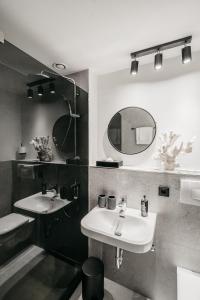 a bathroom with two sinks and a mirror at Hotel Riesengebirge in Neuhof an der Zenn