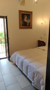 A bed or beds in a room at B&B DIMORA PALMIERI