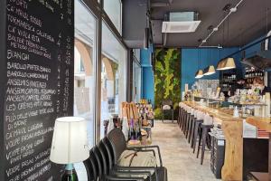 un ristorante con sedie e un bar con bottiglie di vino di enJoy Home - Monolocale S Sofia sui tetti di Padova a Padova