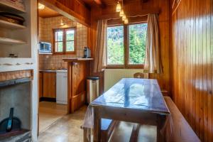 a kitchen with a wooden table in a room at Chalet Fauvette in Morzine