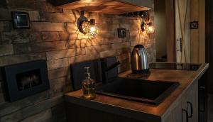a kitchen with a sink and a brick wall at Dunavska Kuća in Smederevo