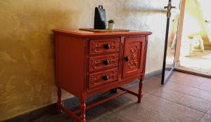 a wooden dresser with a black bag on top of it at Dunavska Kuća in Smederevo