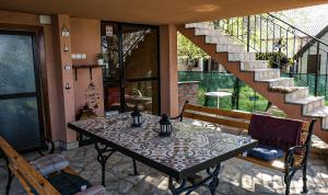 a table and chairs in a room with a staircase at Dunavska Kuća in Smederevo