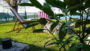 two chairs sitting in the grass in a yard at Dunavska Kuća in Smederevo