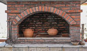 a brick oven with two clay pots in it at Dunavska Kuća in Smederevo