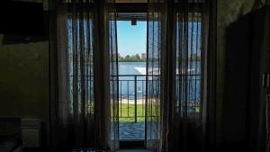 a room with a window with a view of the water at Dunavska Kuća in Smederevo