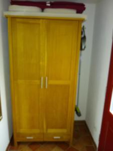 a wooden cabinet in a corner of a room at Ferienwohnung Amende in Angermünde