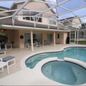 a large swimming pool in front of a house at Mike & Christine's West Haven Vacation Home in Davenport